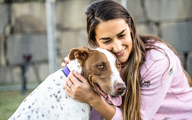 Poppy and their foster owner cuddling